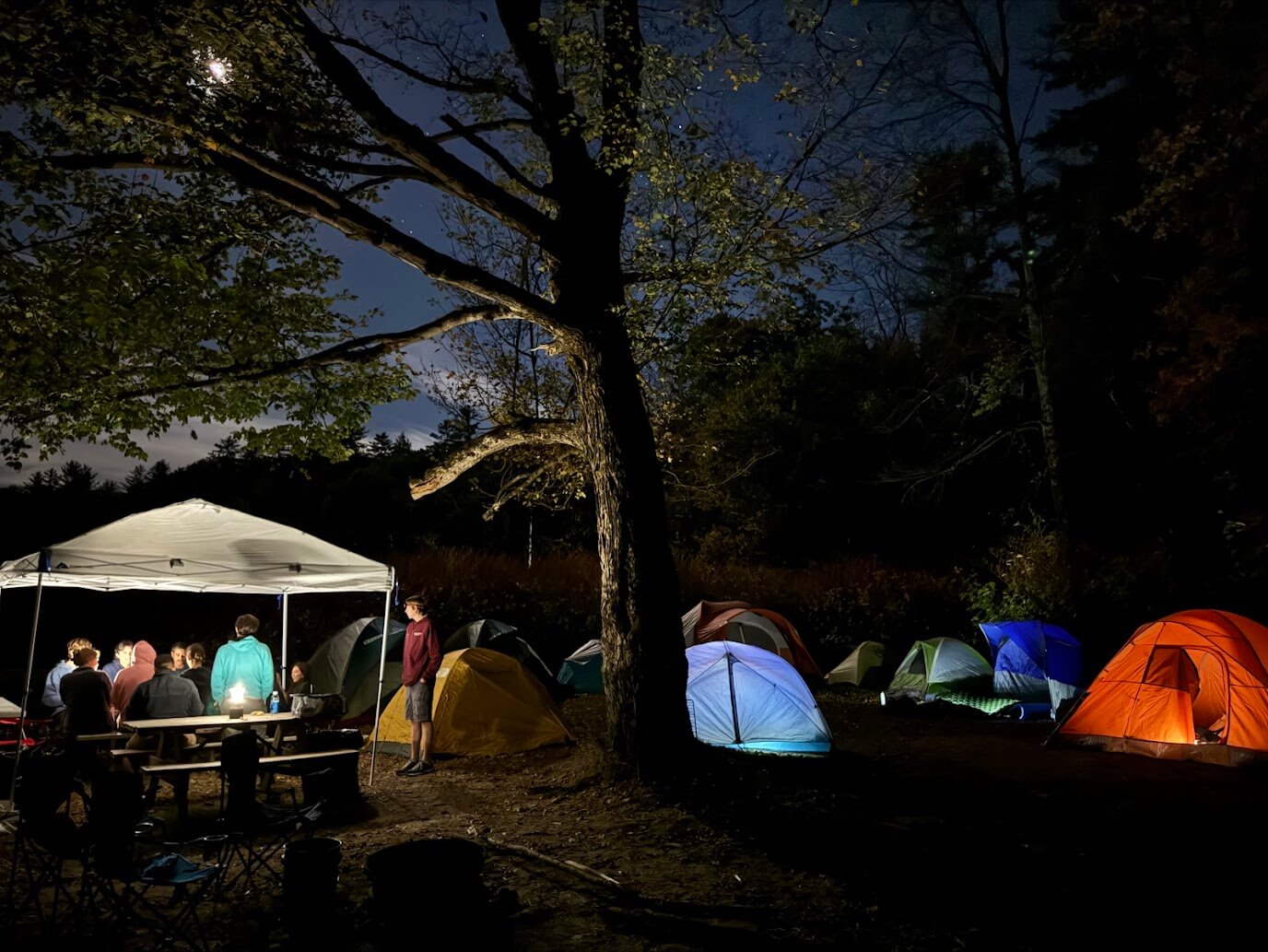 Three climbers from Northeastern University's climbing club climbing an outdoor cliff