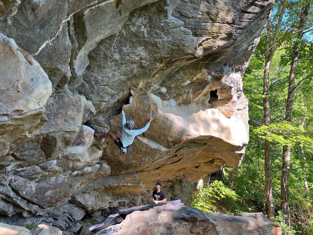 A Northeastern Recreational Club climber climbing sport climbing at Rumney in New Hampshire